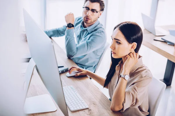 Focused interracial business colleagues working on project together at workplace in office — Stock Photo