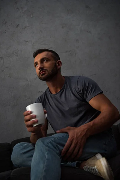 Bottom view of lonely man holding coffee cup at home — Stock Photo