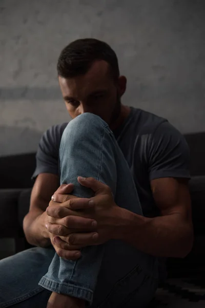 Upset depressed man sitting at home, selective focus — Stock Photo