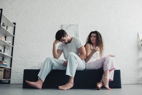 Low angle view of young couple quarreling in bedroom, relationship difficulties concept — Stock Photo