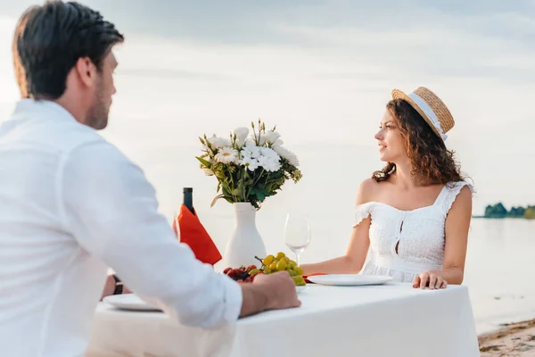 Happy young couple having romantic date near sea — Stock Photo