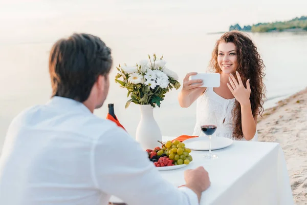 Happy woman taking selfie with proposal ring on finger — Stock Photo