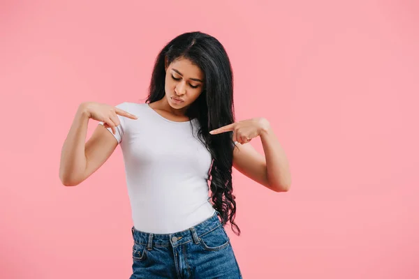 Portrait of beautiful african american woman pointing at blank white shirt isolated on pink — Stock Photo