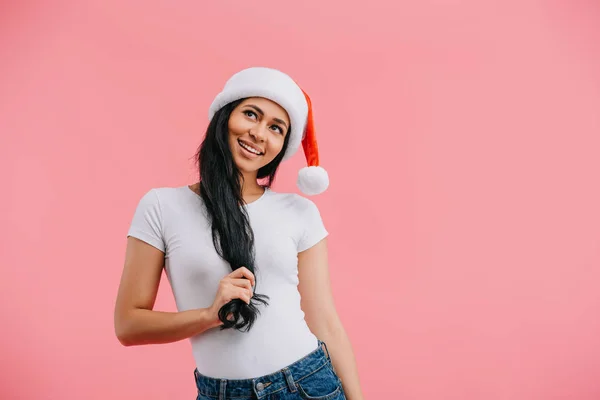 Portrait of dreamy african american woman in santa claus hat isolated on pink — Stock Photo