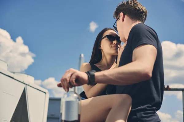 Hot interracial couple flirting on roof — Stock Photo