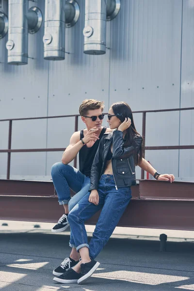 Stylish multicultural couple smoking cigarette together — Stock Photo