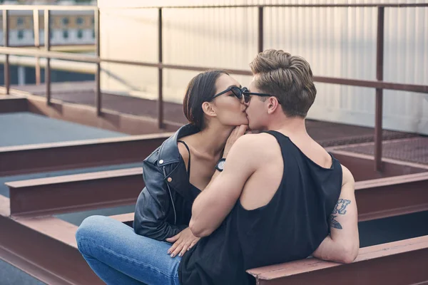 Interracial stylish hot couple kissing on urban roof — Stock Photo