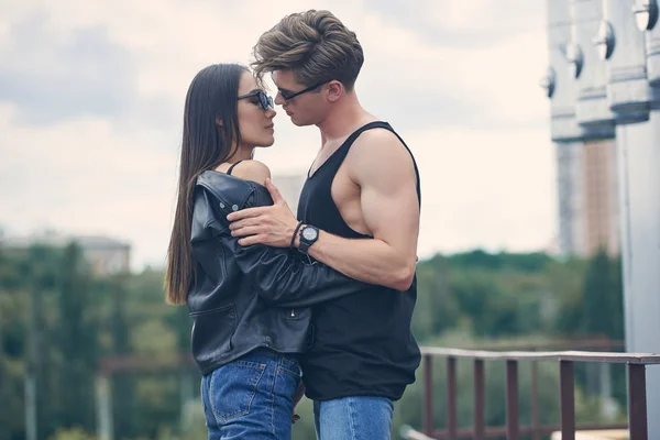 Multiethnic hot couple going to kiss while standing on urban roof — Stock Photo