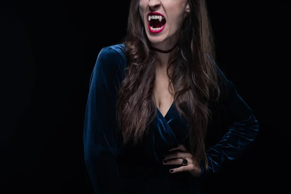 Vue recadrée de la femme montrant des dents de vampire isolées sur noir — Photo de stock