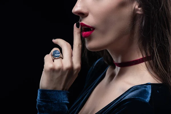 Cropped view of vampire showing silence symbol isolated on black — Stock Photo