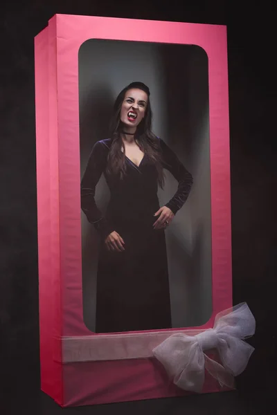 Scary vampire woman in pink doll box — Stock Photo