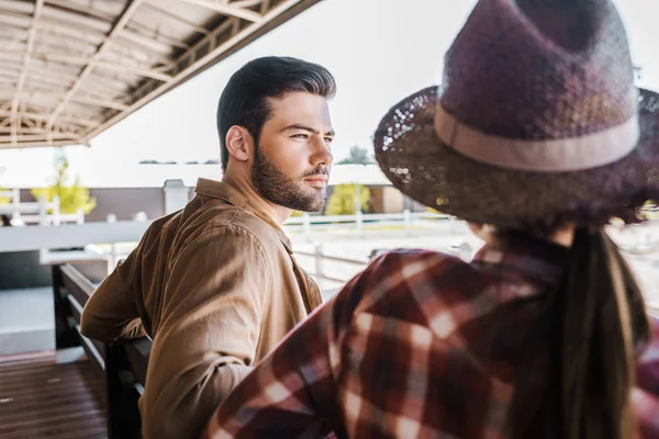 Rückansicht von Reitern in Freizeitkleidung, die auf Bank im Ranch-Stadion sitzen — Stockfoto