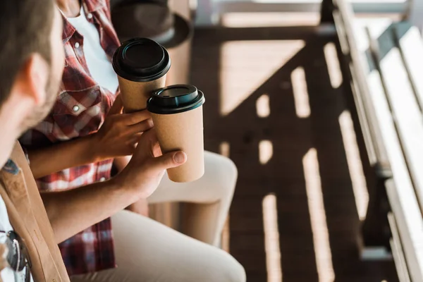 Cropped image man and woman clinking with coffee in paper cups at ranch — Stock Photo