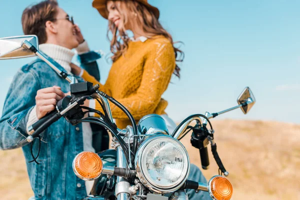 Foco seletivo de casal sorridente sentado em motocicleta vintage — Fotografia de Stock
