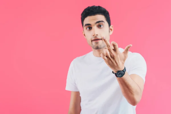 Selective focus of irritated man showing middle finger isolated on pink — Stock Photo