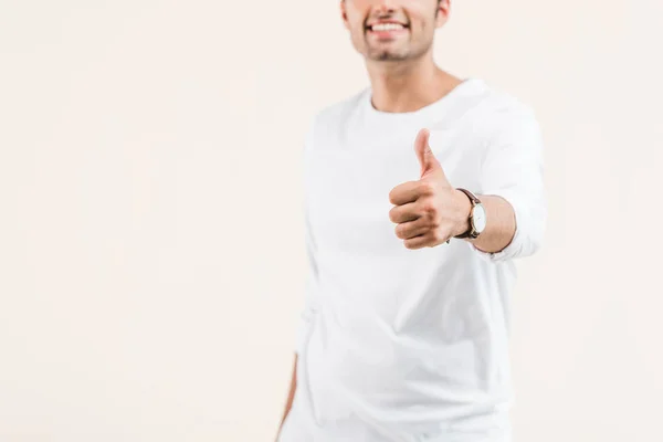 Cropped shot of smiling young man showing thumb up isolated on beige — Stock Photo