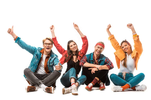Happy male hipster man in denim jacket showing thumbs up while his friends sitting near isolated on white — Stock Photo