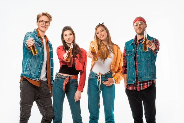 Cheerful young hipster friends showing beer bottles isolated on white — Stock Photo