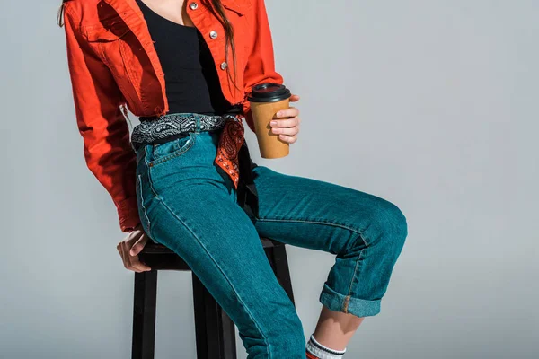 Cropped view of girl holding coffee to go isolated on grey — Stock Photo