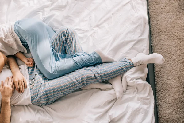 Cropped shot of couple in pajamas sleeping in bed in morning — Stock Photo