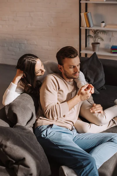 Beautiful romantic couple relaxing together on couch at home — Stock Photo