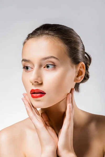 Young beautiful woman with red lips touching face — Stock Photo