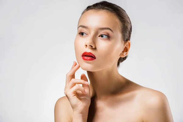 Young beautiful woman with red lips touching face — Stock Photo