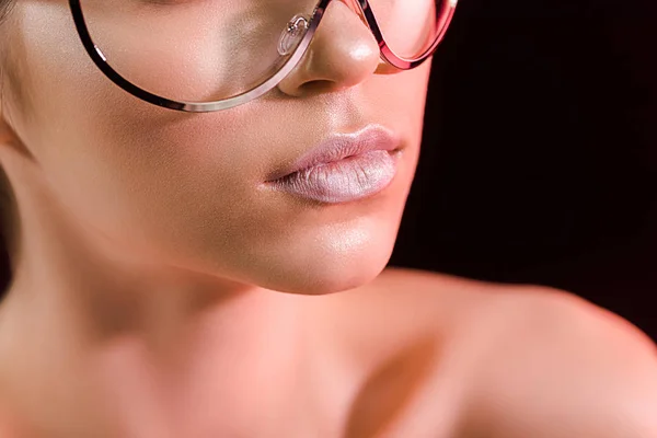 Cropped shot of woman with pink lipstick on lips isolated on black — Stock Photo