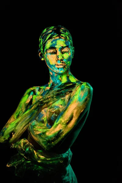 Portrait of woman painted with bright neon paints on black backdrop — Stock Photo