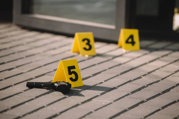 Close up view of crime scene with gun and numbers — Stock Photo