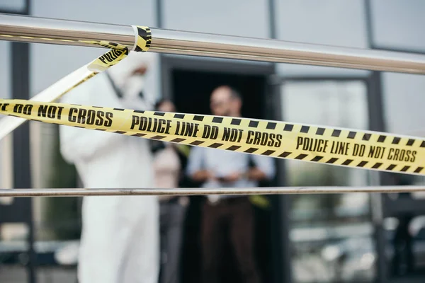 Close up view of police line with blured detectives and criminologist on background — Stock Photo