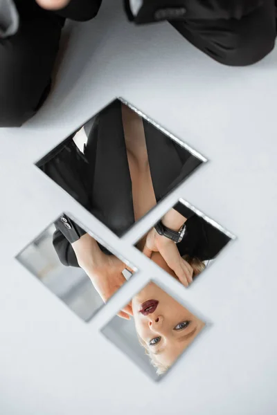 Reflection of attractive fashionable girl in mirrors — Stock Photo