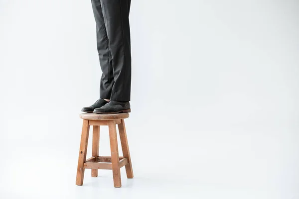 Partial low section view of girl in formal wear standing on steel isolated on grey — Stock Photo