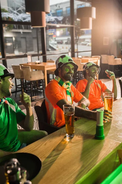 Football fans watching soccer game in bar — Stock Photo
