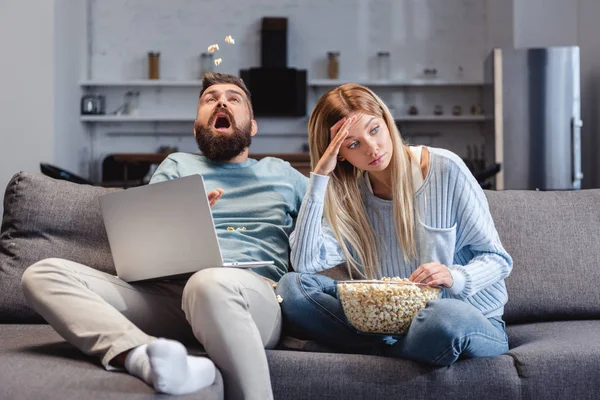 Wife feeling awkwardly near husband with laptop — Stock Photo