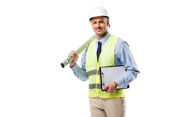 Smiling engineer holding clipboard and spirit level isolated on white — Stock Photo