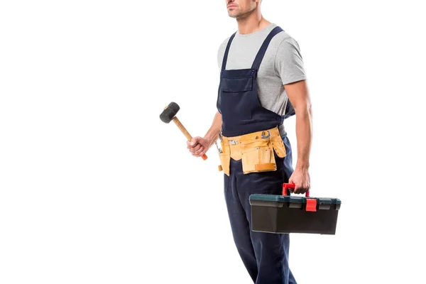 Cropped view of construction worker holding hammer and tool box isolated on white — Stock Photo