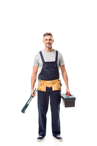 Handsome worker holding pipe wrench and tool box isolated on white — Stock Photo