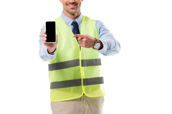 Cropped view of engineer pointing with finger at smartphone with blank screen isolated on white — Stock Photo