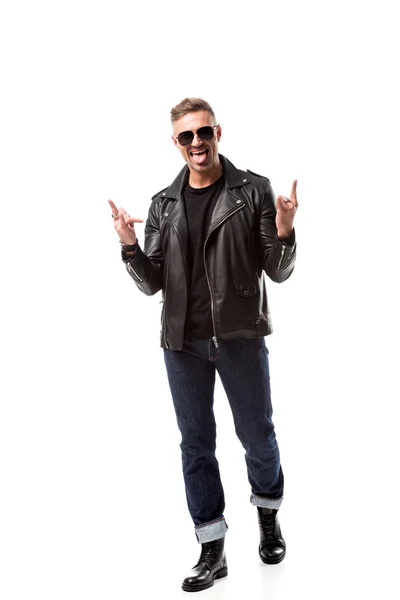 Excited stylish man in leather jacket showing rock signs and sticking out tongue isolated on white — Stock Photo