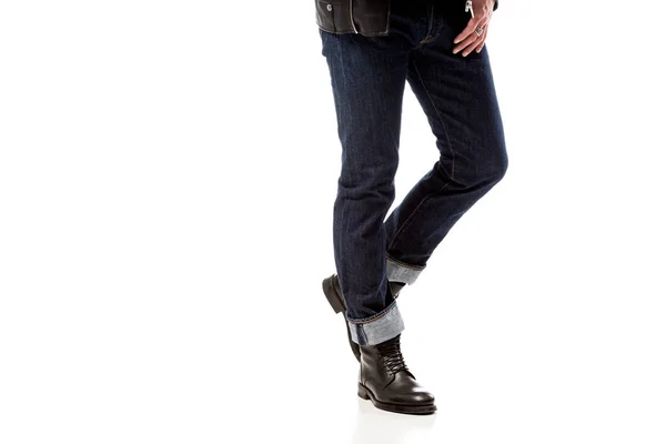 Partial view of stylish man wearing denim and leather boots isolated on white — Stock Photo