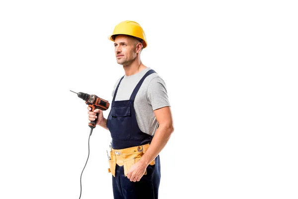 Trabajador de la construcción en el taladro de sujeción de sombrero duro aislado en blanco - foto de stock