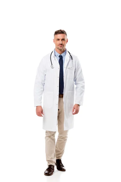 Handsome doctor in white coat with stethoscope looking at camera isolated on white — Stock Photo