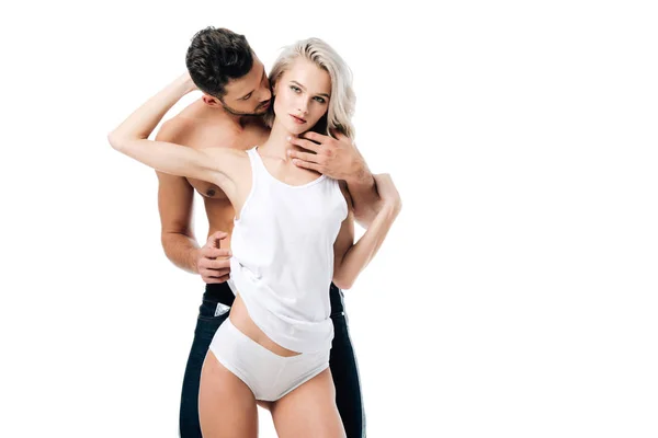 Affectionate shirtless man embracing beautiful young woman isolated on white — Stock Photo