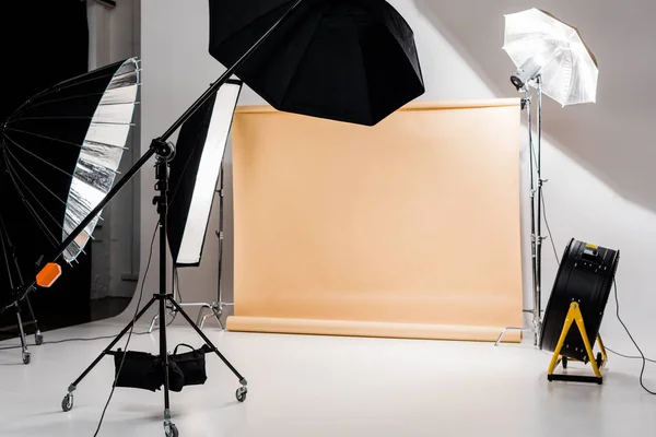 Professional photo and lighting equipment in empty photo studio — Stock Photo