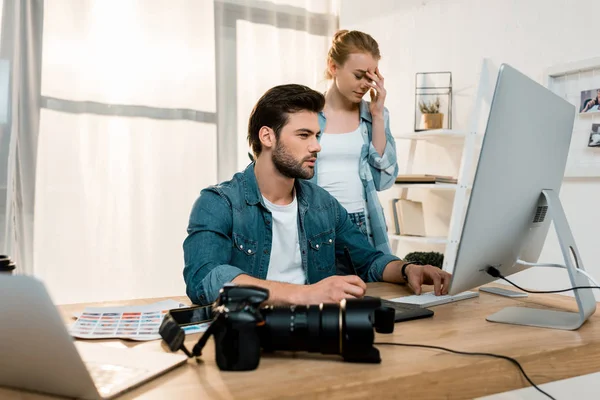 Young professional retouchers working together in office — Stock Photo
