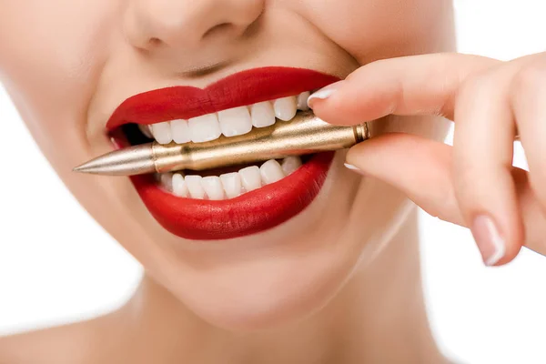 Cropped shot of young woman holding bullet in teeth isolated on white — Stock Photo