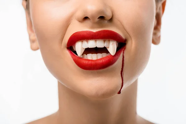 Cropped shot of girl with red lips, vampire fangs and blood on face isolated on white — Stock Photo