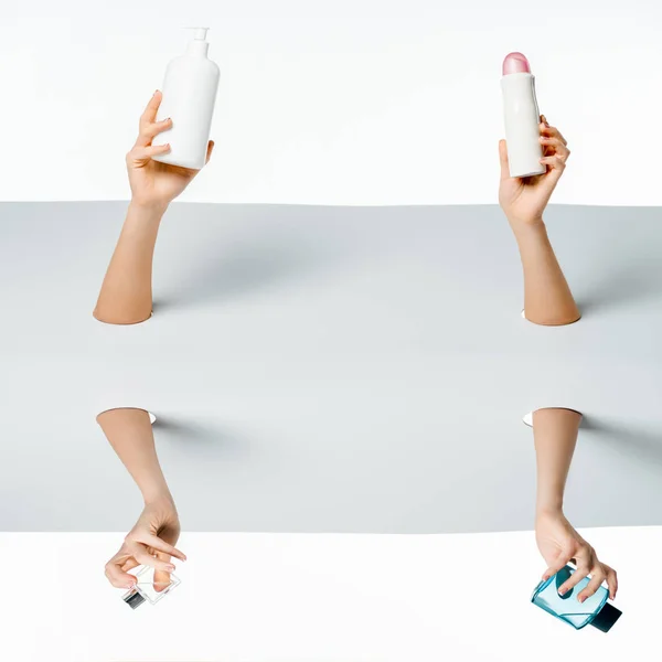 Abgeschnittene Aufnahme von Frauen, die Schönheitsprodukte durch Löcher auf Weiß halten — Stockfoto