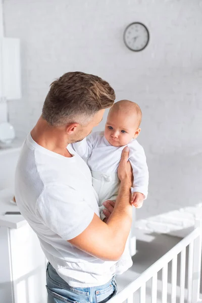 Père regardant bébé fille à la maison — Photo de stock
